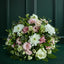 Sympathy Posy Bouquet of pink and white flowers with greenery against a dark green background