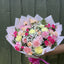 Overhead view of pastel carnation bouquet in pink, peach, lemon and cerise with white gypsophila in blush marble wrap -- Blossom Surprise Northampton
