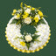 A circular floral wreath featuring white chrysanthemums, yellow roses, white baby's breath, and green foliage, with a pleated yellow base, set against a solid dark green background.