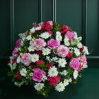 Sympathy Posy Bouquet of pink, white, and red flowers against a dark green background
