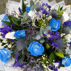 Hand-tied blue rose and purple iris bouquet with silver eryngium thistle, white freesia and eucalyptus, wrapped in marble and gold luxury paper — Blossom Surprise Northampton