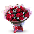 Twenty red roses in blush pink marble wrap with deep red satin ribbon bow, displayed in a gift box — Blossom Surprise Northampton