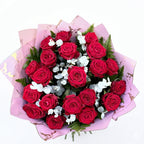 Overhead view of twenty red roses hand-tied with eucalyptus and fern in blush pink marble wrap — Blossom Surprise Northampton