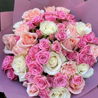 Overhead view of fifty pink and white roses in three shades with pink carnations, wrapped in a wide lilac paper collar -- Blossom Surprise Northampton