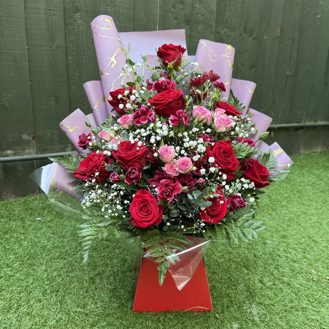 Red rose and pink spray rose box bouquet with burgundy chrysanthemums, cerise carnations and gypsophila in a luxury red gift box with blush marble wrap -- Blossom Surprise Northampton