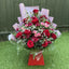 Red rose and pink spray rose box bouquet with burgundy chrysanthemums, cerise carnations and gypsophila in a luxury red gift box with blush marble wrap -- Blossom Surprise Northampton