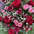 Overhead close-up of deep red roses, pink spray roses and dark chrysanthemums in a luxury box bouquet -- Blossom Surprise Northampton