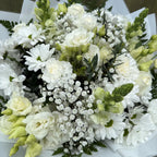 Detail of white bouquet showing white carnations, roses, lisianthus, chrysanthemums and eucalyptus hand-tied by Blossom Surprise Northampton florist
