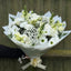 Hand holding a large all-white bouquet of roses, lisianthus, chrysanthemums, snapdragons, carnations and gypsophila in white wrap -- Blossom Surprise Northampton