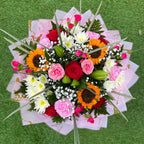 Overhead view of sunflower, rose and carnation bouquet with lily buds, white chrysanthemums and gypsophila in blush pink and gold wrap -- Blossom Surprise Northampton