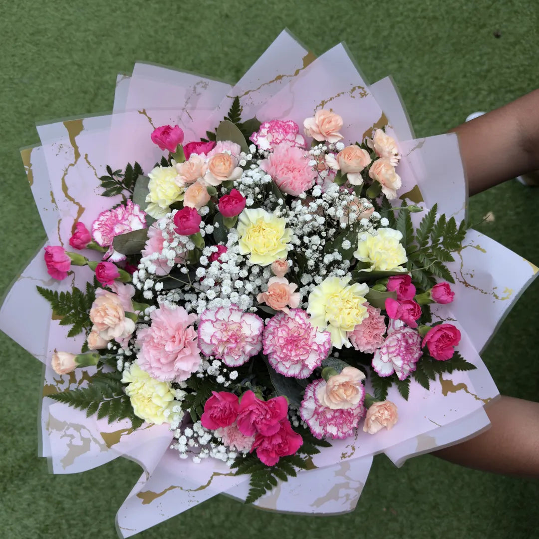 Pastel carnation bouquet with standard and spray carnations in soft pink, peach and yellow tones with gypsophila -- Blossom Surprise Northampto
