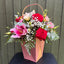 Red and cream rose, pink lily and lisianthus flower arrangement in a rose gold gift bag with carrying handle -- Blossom Surprise Northampton