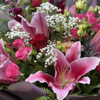 Detail of stargazer lily petals with red rose, pink spray roses and gypsophila in bouquet -- Blossom Surprise Northampton