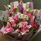 Overhead view of stargazer lily and rose bouquet with purple snapdragons, thistle and lisianthus -- Blossom Surprise Northampton
