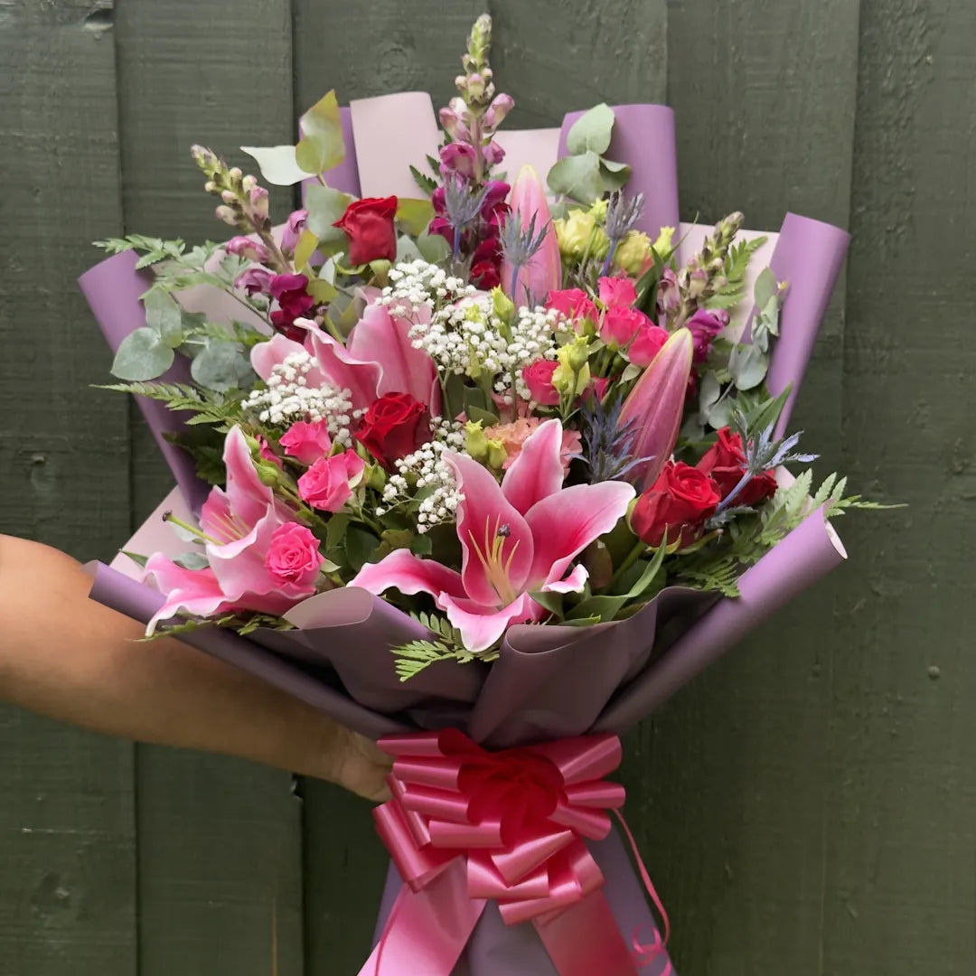 Stargazer lily bouquet hand-tied with roses, snapdragons and thistle, finished with hot pink satin ribbon -- Blossom Surprise Northampton