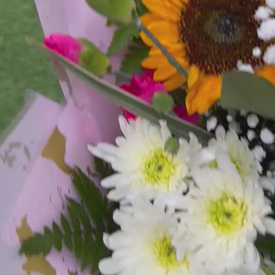 view of sunflower, rose and carnation bouquet with lily buds, white chrysanthemums and gypsophila in blush pink and gold wrap -- Blossom Surprise Northampton